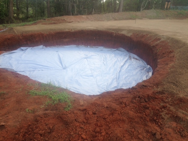 Adding a layer of plastic helps keep weeds from growing in the sand.