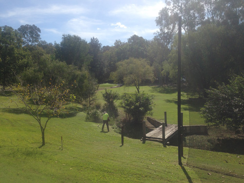 View from the back tee. The green is located above the workers head. You can see the bunker on the right and if you look closely you can see the one on the left.